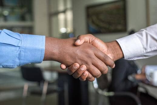 two people networking and shaking hands